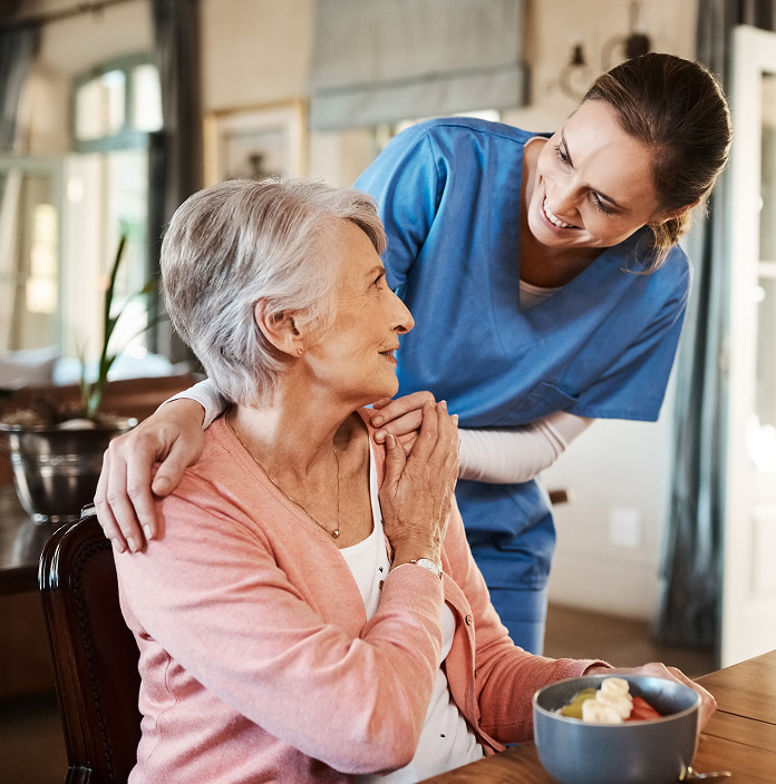 Personal Care Assistance being given to elderly woman by caregiver